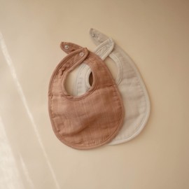 mushie Muslin Baby Bib | Soft Cotton for Infant Drips, Drools & Feedings | Adjustable Fit | 2 Pack (Tan/Fog)