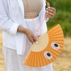 Fisura Hand Held Fan with Eye-Catching Orange Eye Pattern Modern