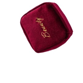 A Portable Beauty Companion　This Burgundy Suede Hanging Bag effortlessly Holds Items Such as Lipsticks and Earrings.