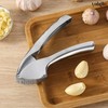 Garlic press includes cleaning brush and silicone peeler that is