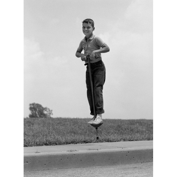1960s Boy Jumping On Pogo Stick Poster Print By Vintage