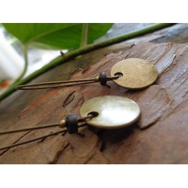 Thick bronze discs and ceramic earrings and kidney hooks