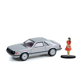 ModelToyCars 1979 Ford Mustang Coupe GHIA and Woman in a Dress Figurine, Silver Metallic - Greenlight 97120B/48-1/64 Scale Diecast Car
