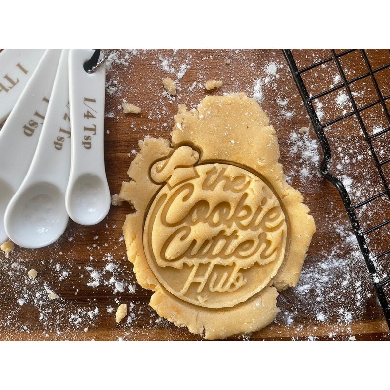 The Cookie Cutter Hub Ausstechform mit Weihnachtsschleife und passender Prägung
