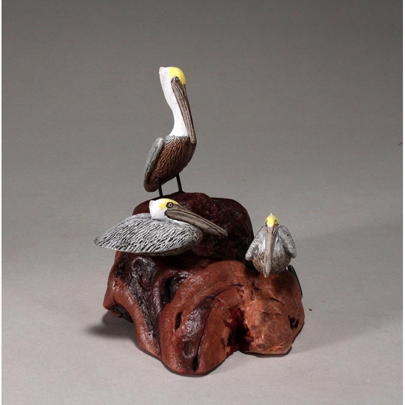 Brown Pelican Trio by John Perry Sculpture on Polished burlwood