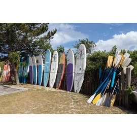 Photo- Kayaks, windsurfer boards, and paddles at North Duck Watersports in Duck, a community named for the plethora of waterfowl in the area, in North Carolina's Outer Banks 24in x 16in