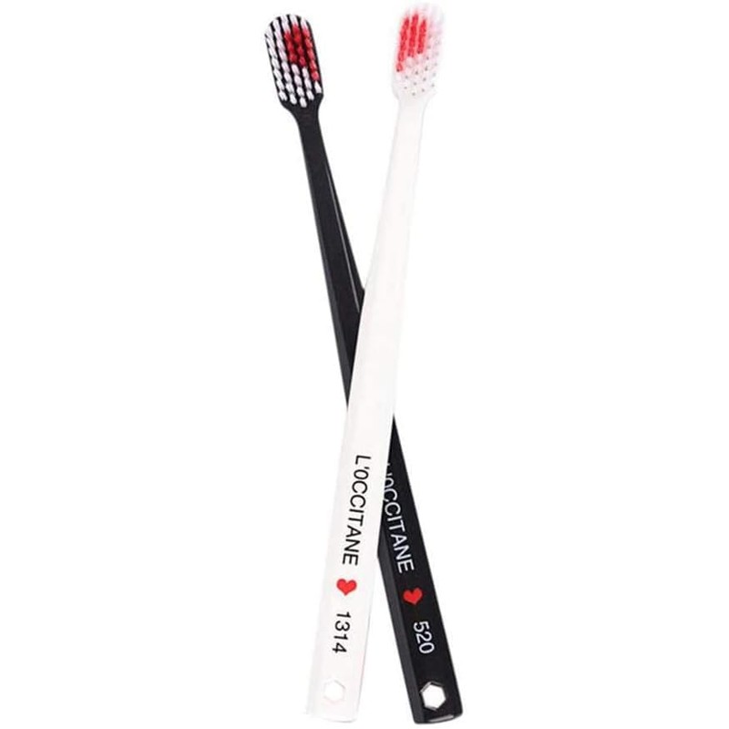 2 cepillos de dientes blancos y negros en forma de