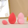 A set of two large and one mini makeup sponge