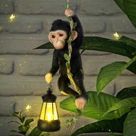 Rossesay Solar Light Outdoor Statues 7.48'' H Resin Chimpanzee Baby Monkey Climbing On A 19.68" L Vine with LED Lantern Waterproof Hanging Monkey Figurine with Hook for Yard Garden Wall (Black)