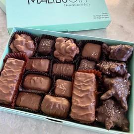 Nuts and chews gourmet candy box. 1 lb candy box of dark and milk chocolate candies with assorted clusters of nuts, pecan crunch bars, caramels, and nougats.