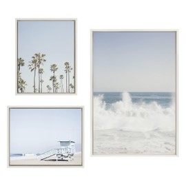 Kate and Laurel Sylvie Waves Crashing; Palm Tree Paradise and Pale Blue Lifeguard Tower Framed Canvas Wall Art Set by Caroline Mint; Set of 3; two 16x20 and one 23x33 White; Coastal Calming Wall Decor For Your Living Room or Bedroom