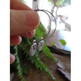 Delicate stainless steel hoop earrings with perforated Miao Thai disc. Anti-allergic ethnic tribal earrings