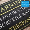 Black And Gold ‘WARNING' '24 HOUR VIDEO SURVEILLANCE’ Warning Sign.