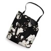 White Magnolias Floral Pattern on a Black Background Tote Bag